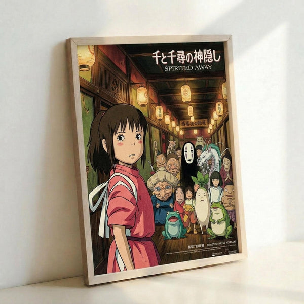 May include: Framed poster of animated film artwork showing young girl with dark hair in red outfit standing in traditional Japanese street scene with paper lanterns overhead. Behind her are various colorful animated characters including spirits and creatures. The artwork features warm lighting and detailed animation style. Japanese text appears at top with English subtitle below. Light wooden frame displayed against white wall corner.