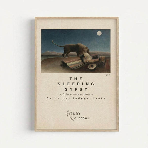 May include: Framed art print displayed on white wall showing Henri Rousseau's famous painting of a sleeping figure in colorful striped clothing lying in a desert landscape with a lion standing nearby under a full moon. The poster includes exhibition-style text below the image with the artwork title, date 1897, and artist name. Natural wood frame with cream matting.