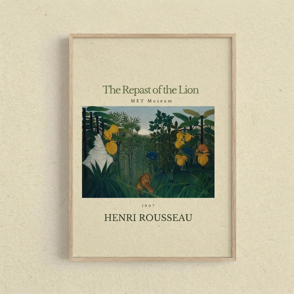 May include: Framed poster print of Henri Rousseau's jungle painting displayed on cream textured wall. The artwork shows a lush tropical scene with dense green foliage, yellow flowers, and a small lion resting among the plants. Light wooden frame surrounds the museum-style print with cream matting and dark text identifying the piece and artist.