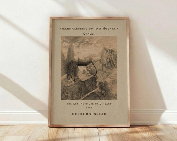 May include: Framed vintage botanical print showing hikers climbing toward a mountain chalet, rendered in sepia tones with detailed landscape illustration. The artwork features rolling hills, trees, and small figures on a winding path. Text reads "Hikers Climbing Up to a Mountain Chalet," "The Art Institute of Chicago 1888," and "Henri Rousseau." Light wood frame sits on wooden floor against white wall with soft natural lighting.