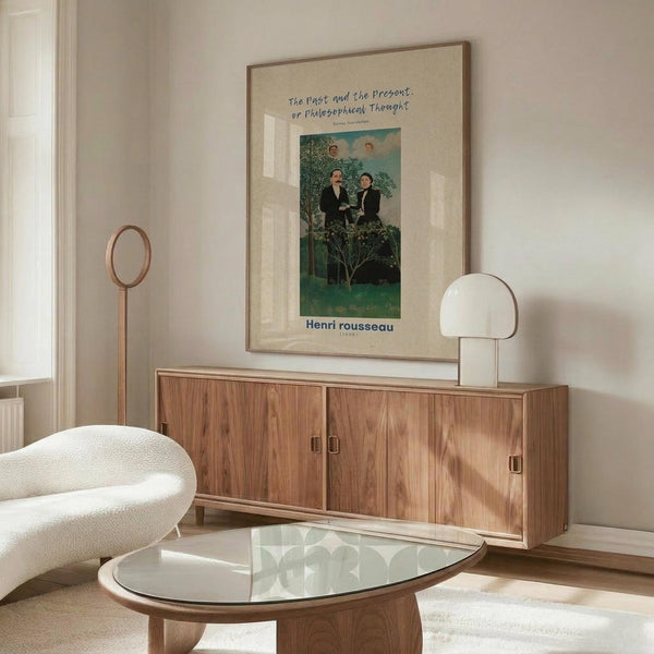 May include: Henri Rousseau art print in light wood frame hanging above walnut credenza in minimalist living room. Poster features two men in dark suits standing in lush green landscape with trees. Room has cream walls, white curved chair, glass oval coffee table, and modern brass lamp. Natural lighting creates warm, contemporary atmosphere showcasing the vintage botanical artwork.