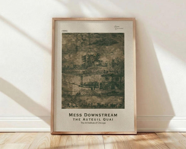 May include: Framed vintage art print showing a sepia-toned etching of buildings along a waterfront quai from 1885. The artwork depicts historic architecture with trees and cloudy skies in muted brown and green tones. Displayed in a thin wooden frame with cream matting against a white wall with natural window light casting diagonal shadows. The print sits on light wood flooring, showing museum exhibition text below the image.