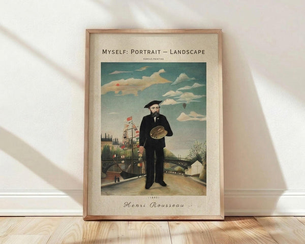 May include: Framed art print leaning against white wall on light wood floor. Features Henri Rousseau's self-portrait showing bearded man in black suit and beret holding artist's palette, standing before bridge and landscape with cloudy sky. Cream mat with vintage-style typography, natural wood frame. Soft window light creates shadows on wall.