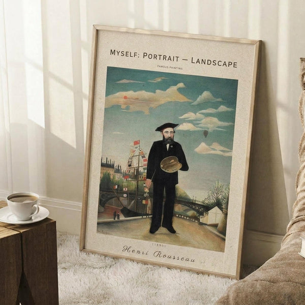 May include: Framed vintage-style poster print of Henri Rousseau's self-portrait showing a bearded man in dark suit and beret holding artist's palette, standing before industrial landscape with windmill and bridge. Cream matting with decorative text. Frame leans against white paneled wall beside wooden side table with white coffee cup and saucer, positioned on textured cream rug next to beige upholstered furniture.
