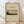 May include: Framed poster print featuring Mount Fuji landscape artwork in muted earth tones with trees in foreground, displayed in light wood frame against white wall on wooden floor with soft natural lighting and shadows