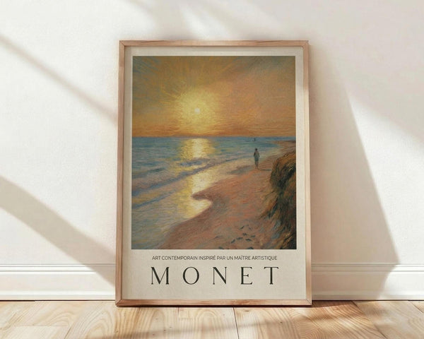 May include: Framed poster featuring an impressionist-style sunrise seascape with golden sun reflecting on blue water, solitary figure walking on sandy beach, warm orange and yellow sky. Natural wood frame with white matting displays "MONET" text below artwork. Poster leans against white wall on light wooden floor with soft natural lighting creating gentle shadows.