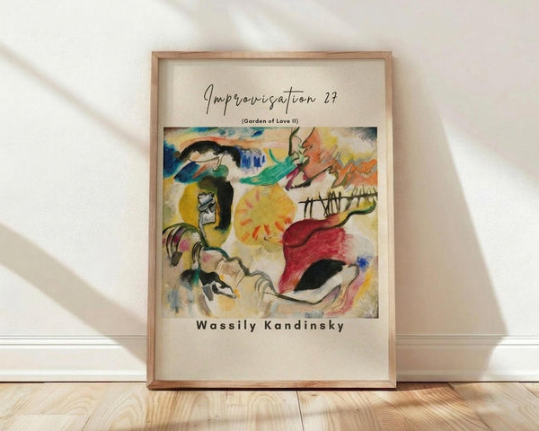 May include: Framed abstract art print leaning against white wall on light wood floor. Colorful expressionist painting features swirling brushstrokes in vibrant yellows, reds, blues, and greens with organic flowing forms. Light wood frame contains cream matting with black text above and below the artwork. Soft natural lighting creates diagonal shadows across the scene.