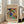 May include: Large framed art print leaning against white wall next to beige sofa in bright living room. Abstract colorful artwork features swirling blues, yellows, reds, and greens with dynamic brushstrokes and geometric elements. Cream matting with gallery-style text layout in light wood frame. Natural lighting from tall windows creates soft shadows on hardwood floors.