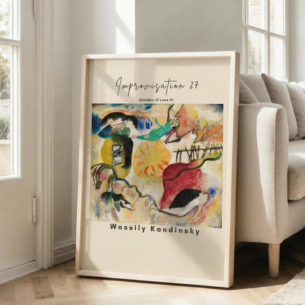 May include: Framed abstract art print leaning against white wall next to beige sofa in bright living room. Colorful expressionist painting features bold brushstrokes in yellows, blues, greens, and reds with fluid organic forms. Light wood frame with white mat displays the vibrant artwork on hardwood floors near large windows.