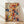May include: Abstract expressionist artwork in wooden frame leaning against white wall on light wood floor. Vibrant paint splatters and drips in red, blue, yellow, and black dance across cream background. Dynamic brushstrokes and gestural marks create energetic composition with scattered dots and flowing lines throughout.