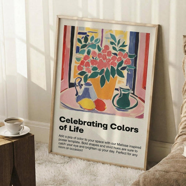 May include: Colorful Matisse-inspired still life poster in light wood frame leaning against white wall. Features vibrant orange vase with red flowers, green leaves, blue teapot, green pitcher, and fruit on pink table with striped background. Displayed in cozy room setting with white coffee cup on wooden stool and beige textured rug.