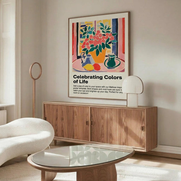 May include: Colorful Matisse-style poster in wooden frame hanging above walnut credenza in modern living room. Artwork features vibrant still life with flowers in orange vase, fruits, and pottery in bold reds, blues, yellows, and greens. Room has cream walls, white curved chair, glass oval coffee table, and brass floor lamp. Natural lighting creates warm, contemporary atmosphere.