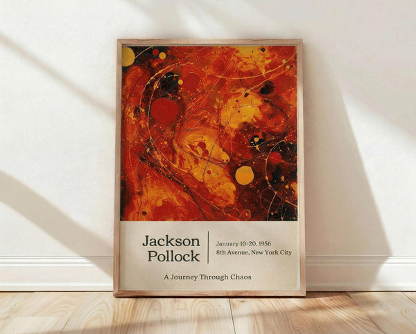 May include: Framed abstract art poster featuring vibrant red, orange, and yellow swirls with black paint splatters and circular elements in Jackson Pollock's signature drip painting style. The artwork is displayed in a light wood frame against a white wall with natural lighting creating soft shadows. Exhibition text below reads "Jackson Pollock January 10-20, 1956 8th Avenue, New York City A Journey Through Chaos" on cream background.