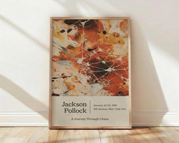 May include: Framed abstract art poster leaning against white wall on light wood floor. Features Jackson Pollock-style paint splatters in orange, black, and cream with white drip lines. Poster shows exhibition details below artwork in clean typography. Natural wooden frame, soft window lighting casting diagonal shadows across white textured wall.