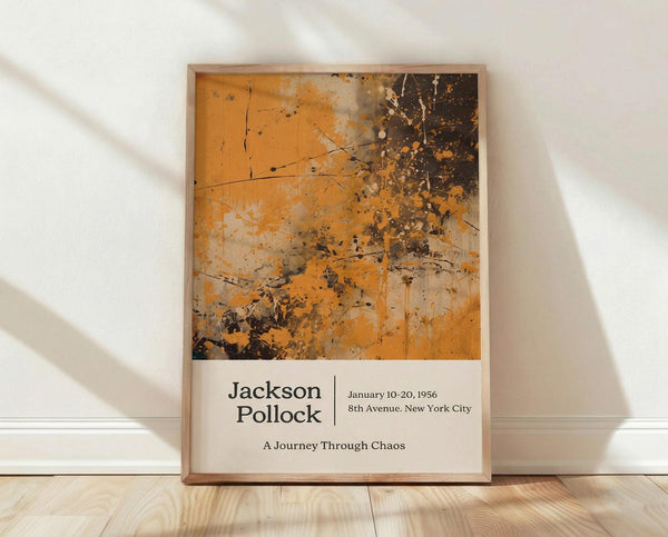 May include: Framed abstract art poster with orange, brown and black paint splatters in Jackson Pollock's signature drip style, displayed against white textured wall on light wood floor. Natural sunlight creates diagonal shadows across the scene. The artwork features chaotic paint drips and splatters with exhibition text below reading dates and location details.