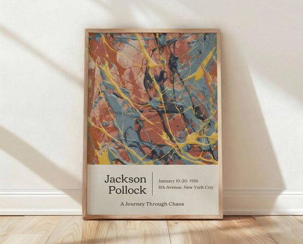 May include: Framed Jackson Pollock exhibition poster leaning against white textured wall on light wood floor. Abstract artwork features energetic splashes and drips in orange, blue, yellow, and black paint. Poster has cream bottom section with black text reading artist name, exhibition dates January 10-20, 1956, 8th Avenue New York City location, and "A Journey Through Chaos" subtitle. Natural wood frame surrounds the print. Soft shadows cast across the minimal room setting.