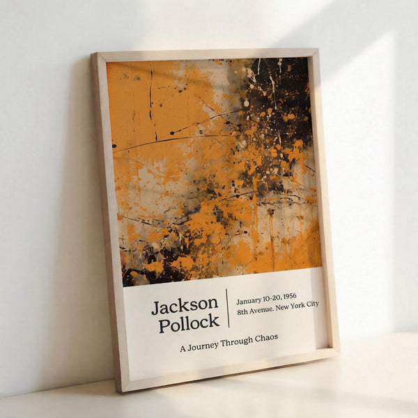 May include: Framed abstract art poster in light wood frame leaning against white wall. Features orange and black paint splatters and drips in Jackson Pollock's signature drip painting style. White bottom section displays artist name, exhibition dates "January 10-20, 1956", location "8th Avenue, New York City", and subtitle "A Journey Through Chaos". Modern museum exhibition poster design with clean typography.