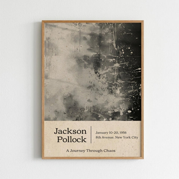 May include: Framed poster on white wall featuring abstract black and gray paint splatters and drips in Jackson Pollock's signature style. Light wood frame surrounds cream-colored background with exhibition-style text reading "Jackson Pollock January 10-20, 1956 8th Avenue, New York City A Journey Through Chaos" in black typography below the chaotic brushwork artwork.