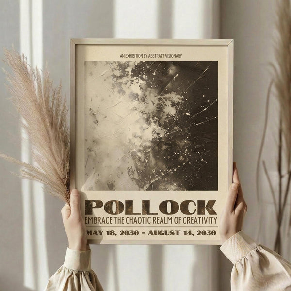 May include: Person holding a framed vintage-style exhibition poster featuring abstract black and white paint splatters and scratches. The beige poster displays "POLLOCK" and "EMBRACE THE CHAOTIC REALM OF CREATIVITY" with exhibition dates. Natural lighting illuminates cream curtains in background, with dried pampas grass held in other hand, creating an artistic styling scene.