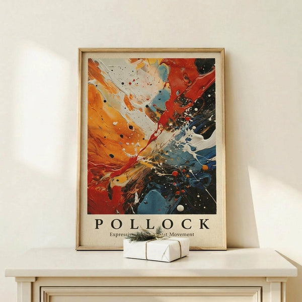 May include: Abstract expressionist artwork poster in wooden frame leaning against white wall on light wood surface. Vibrant painting features explosive splashes and drips of orange, red, blue, black and white paint with dynamic movement radiating from center. Text reads "POLLOCK Expressionist Art Movement" below colorful composition. Small white wrapped gift with green sprig sits in front of frame.