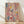 May include: Abstract expressionist style artwork in wooden frame leaning against white wall on light wood floor. Colorful paint splatters and drips in pink, blue, yellow, red, and cream create dynamic composition with black linear elements and organic shapes scattered across canvas. Soft natural lighting casts shadows on textured wall surface.