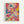 Abstract expressionist artwork featuring energetic paint splatters, drips, and gestural brushstrokes in vibrant pink, blue, yellow, black, and white. Dynamic lines and color patches create movement across the composition, with paint drips and splashes scattered throughout. The piece is displayed in a light wooden frame against a white wall, showcasing the spontaneous, action-painting style with overlapping colors and bold gestural marks.