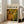 May include: Framed abstract art poster with swirling green, yellow, and brown paint drips and splatters in Jackson Pollock's signature style, leaning against white wall next to beige upholstered chair in bright, naturally-lit room with large windows and light wood floors
