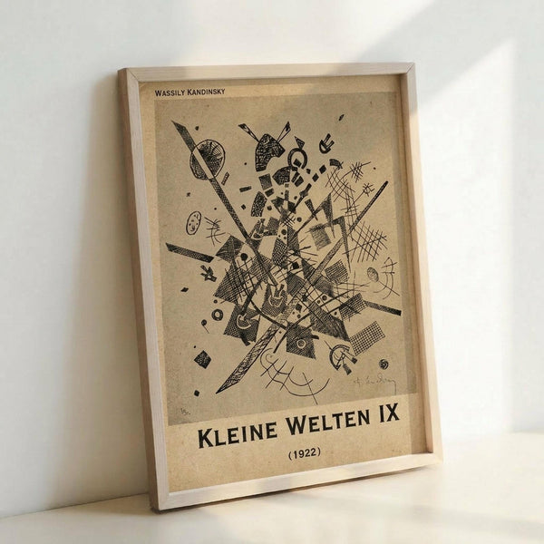 May include: Framed abstract art print in light wood frame leaning against white wall. Black ink geometric composition on cream background featuring intersecting lines, cross-hatched shapes, circles, and angular forms in Kandinsky's distinctive abstract style. The artwork appears aged with vintage beige tones and shows intricate linear details throughout the dynamic composition.