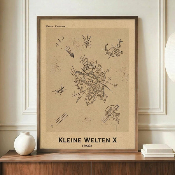 May include: Framed abstract art print in warm beige tones featuring geometric lines, dots, and angular shapes in black ink. The minimalist poster displays intricate linear patterns radiating from a central composition, surrounded by smaller scattered elements. Shown in thin brown frame on wooden sideboard next to white ceramic vase and stacked books in bright room with white walls and crown molding.