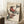 May include: Framed vintage-style Japanese woodblock print featuring two colorful birds perched on bamboo branches, displayed in a cozy room setting with white walls, wooden side table with coffee cup, and beige textiles. The artwork shows detailed illustrations in muted earth tones with the artist's name at the top.