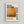 May include: Framed art print hanging on white wall featuring abstract painting in warm orange, yellow and brown tones with "MARK ROTHKO" text and "09.1903 02.1970" dates. Light wood frame with white matting surrounds cream-colored poster with descriptive text about the artist below the artwork image.
