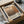 a framed poster or artwork with text and an abstract design, placed in a cardboard box.