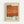 May include: Framed vintage-style poster featuring Mark Rothko's name in bold black typography above an abstract orange-red painted section with weathered, textured appearance. Below shows "Rothko" in large letters with "02.1970" vertically aligned, plus small biographical text block. Light wood frame against white wall with natural lighting creating subtle shadows.