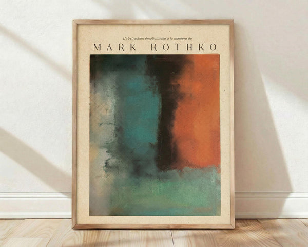 May include: Framed abstract art print in light wood frame leaning against white wall on wooden floor. The artwork features soft, blended color fields in teal, orange, green and gray with organic, flowing boundaries. French text above reads "L'abstraction émotionnelle à la manière de" followed by "MARK ROTHKO" in large letters. Natural lighting creates subtle shadows on textured white fabric backdrop.