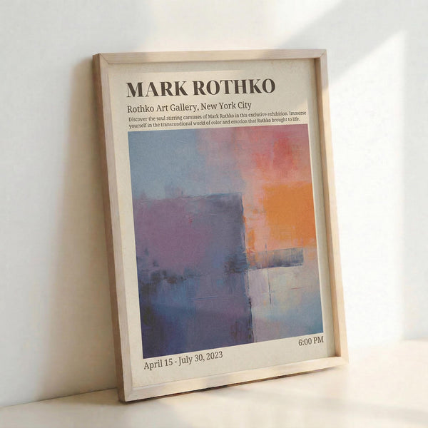 May include: Framed exhibition poster featuring Mark Rothko's abstract artwork with blue, purple, orange and pink color blocks. Light wood frame displaying museum-style poster with text about Rothko Art Gallery New York City exhibition, dated April 15 - July 30, 2023. Poster leans against white wall on light surface, showing soft natural lighting and shadows.