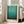 May include: A framed art print featuring Mark Rothko's abstract painting with gradient turquoise and teal color fields, displayed in a light wood frame against a beige couch in a bright living room with white walls and large windows. The poster shows smooth color transitions from lighter turquoise at top to deeper teal at bottom, with museum exhibition text below the artwork.