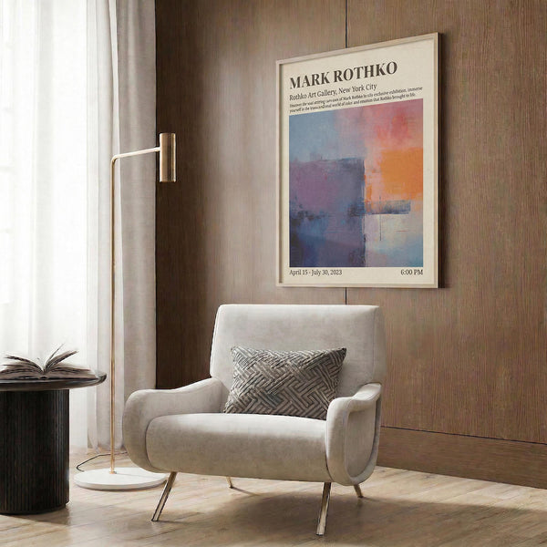 a living room with a white armchair, a floor lamp, and a framed poster on the wall.