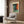 a modern living room with a white armchair, a floor lamp, and a framed abstract painting on the wall.