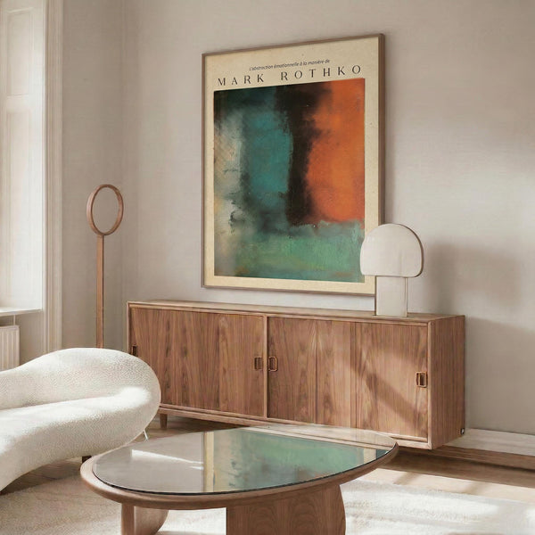 a modern living room with a large abstract painting hanging on the wall above a wooden cabinet. The room has a white sofa, a glass coffee table, and a lamp on a side table.