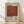 May include: Framed vintage-style art poster with cream background featuring large rusty red square, black text reading "Mark Rothko" and exhibition details "02.19 03.19", descriptive paragraph below. Natural wood frame displayed on light wooden floor against white textured wall with soft window light shadows.