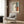 a modern living room with a white armchair, a floor lamp, and a framed abstract painting on the wall.