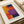 a framed abstract painting with bold, vibrant colors of orange, purple, and blue.