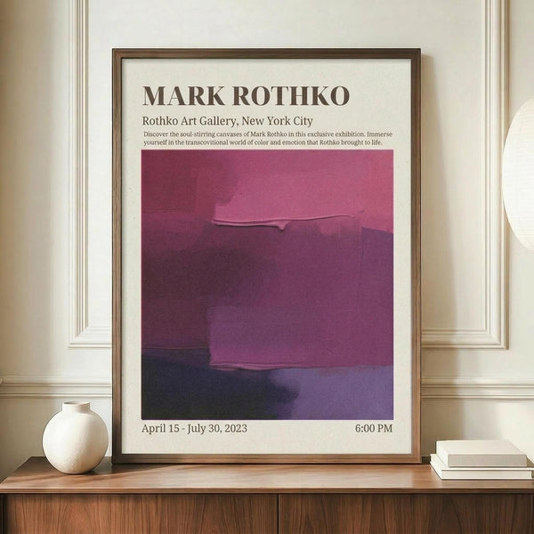 May include: Framed exhibition poster featuring Mark Rothko's abstract color field painting in deep purples and magentas, displayed on a wooden sideboard next to a white ceramic vase and stacked books. The poster shows gallery information and dates from April to July 2023. Warm beige walls with white molding create an elegant interior setting.