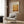 a modern living room with a white armchair, a floor lamp, and a framed poster on the wall.