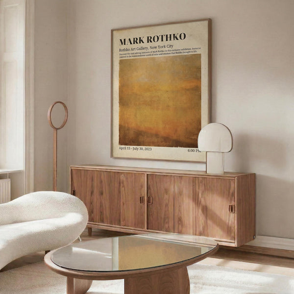 a modern living room with a large wooden cabinet, a white sofa, and a glass coffee table. Above the cabinet, there is a framed poster of Mark Rothko's artwork displayed on the wall.
