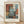 May include: Framed abstract art print featuring overlapping rectangular color blocks in muted blues, oranges, browns, and whites with soft, painterly edges. The artwork is displayed in a light wood frame against a white textured wall with natural lighting casting diagonal shadows. French text appears at the top, with "MARK ROTHKO" prominently displayed below the image along with an inspirational quote about art and adventure.