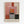 Framed abstract art print featuring geometric rectangular blocks in soft pink, orange, red, gray, and black tones with painterly brushstrokes. The composition shows layered translucent color fields in Rothko's signature style. Text at bottom reads "L'abatoration émotionnelle à la mambre de Mark Rothko" and "MARK ROTHKO" in large letters. Light wooden frame against white wall.