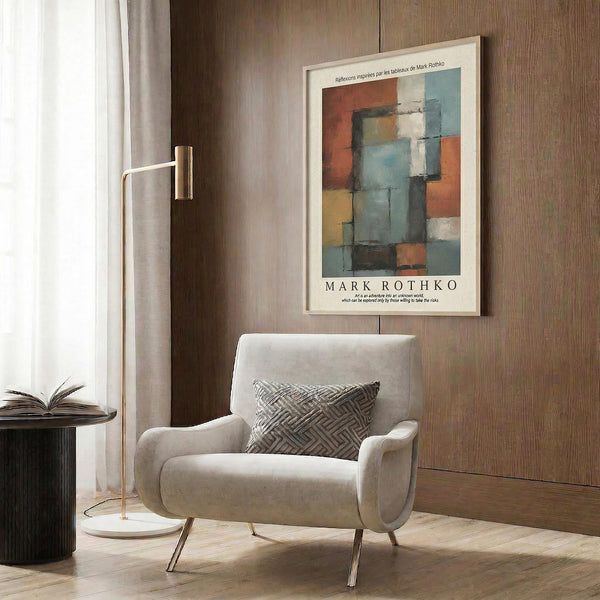 a modern living room with a white armchair, a floor lamp, and a framed abstract painting on the wall.