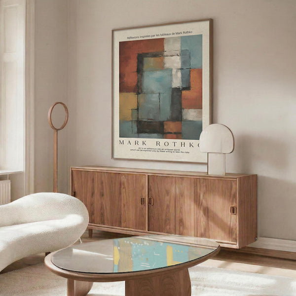 a modern living room with a large abstract painting hanging on the wall above a wooden cabinet. The room has a white sofa, a glass coffee table, and a lamp on a side table.