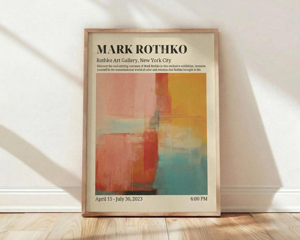 May include: Framed exhibition poster featuring Mark Rothko's abstract color field painting with warm oranges, reds, and cool blues in rectangular blocks. The cream-colored poster displays gallery information and exhibition dates. Natural wood frame leans against white wall on light wooden floor with soft window light creating shadows.